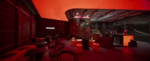 A modern coffee shop interior with red lighting and a sleek, contemporary design.