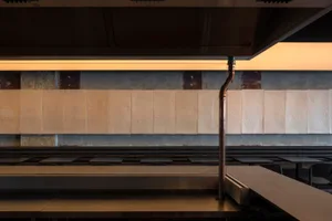 A minimalist concrete bar interior design with metal accents.