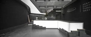 A sleek, minimalist coffee shop interior with a concrete counter and geometric design elements.