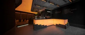 Modern interior of a coffee shop with concrete, wood, and glass materials.