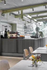 A modern cafe interior featuring a metallic counter.