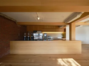 Modern coffee shop with a wooden counter, designed for a sleek and minimalist aesthetic.