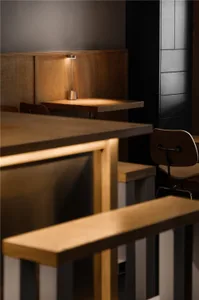 Industrial-style restaurant interior with wooden tables and chairs.