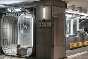 A modern industrial storefront with metal and glass features.
