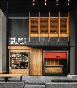 Modern restaurant exterior with black-painted walls and wooden accents.