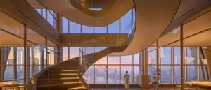 A glass-enclosed space viewed from within, featuring a spiral staircase and a panoramic cityscape.