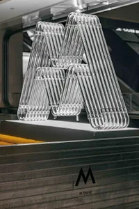 Minimalist metal coat hangers arranged in a triangular pattern for display purposes.