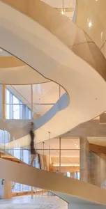 A modern interior design featuring glass and concrete materials.