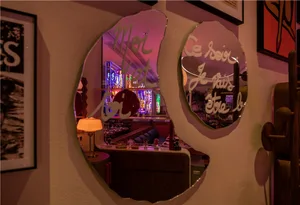 A modern restaurant interior with metallic wall art and stained glass windows.
