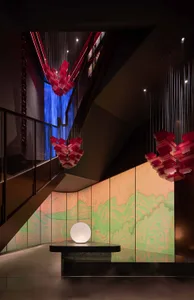 Modern hotel lobby with glass art installations and illuminated globe