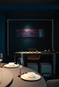 Modern restaurant interior with minimalist design, wooden furniture, and stone accents.