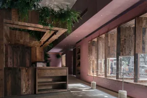 Industrial storefront with wooden materials and hanging plants