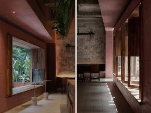 Modern design of a cafe interior featuring concrete walls and wooden elements.