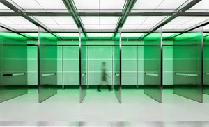 A minimalist interior design featuring glass walls and a white floor.