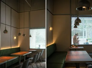 Industrial-style restaurant interior with metal tables and chairs.