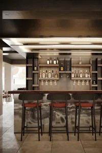 Modern bar interior with wood and concrete materials, featuring a bar counter, shelves with bottles and glasses, and red cush