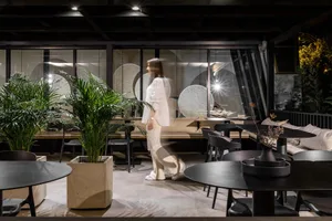 A modern cafe with concrete and glass materials.