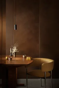 A modern dining room with a wooden table and leather chair.