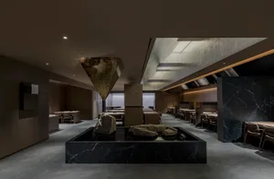 A contemporary restaurant interior featuring luxurious marble materials and sophisticated design elements.