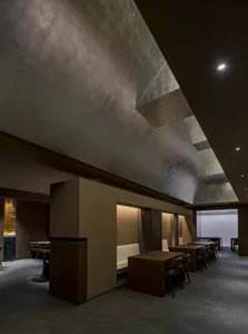 Contemporary restaurant interior with concrete and wood materials.