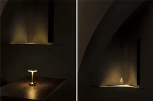 A minimalist interior scene featuring a metal table lamp casting warm light on a wooden surface.