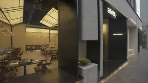 Modern restaurant interior featuring concrete, wood, and glass materials