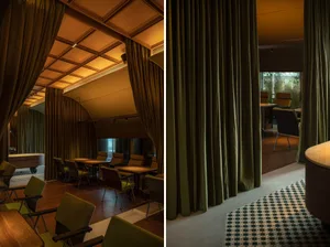 Industrial-style office with green curtains and wooden flooring