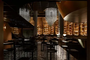 An industrial-style restaurant interior with metallic accents and modern lighting.
