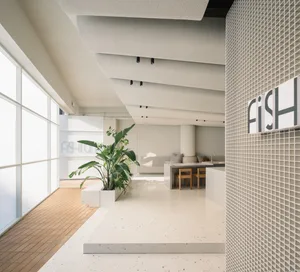Modern office space featuring a minimalist design with concrete walls and floor.