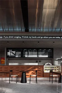 Interior design of a modern coffee shop featuring brick, wood, and metal materials.
