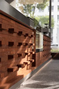 A modern design featuring exposed brick walls and a sleek bar with coffee-making appliances