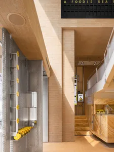 Interior of a modern coffee shop featuring a stone exterior and minimalist design.