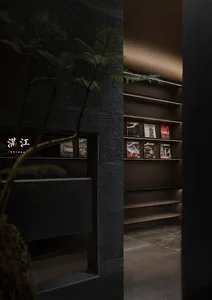 A modern bookshelf with concrete shelving and a sleek, minimalist design.
