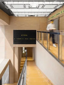Modern food hall interior with concrete and tile materials, minimalist design.