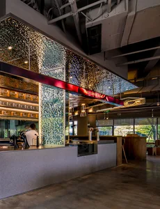 Interior of a modern cafe featuring a glass ceiling with illuminated elements.