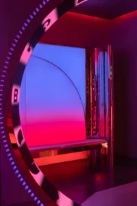 A modern, metallic interior design with geometric shapes and vibrant lighting.