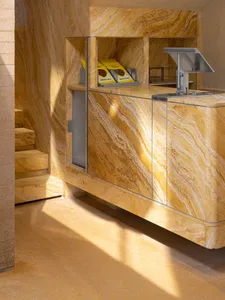 A modern office lobby entrance with marble and glass materials.