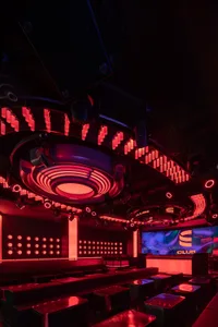 Industrial-style nightclub interior with glass light fixtures and metal seating