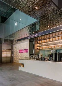 Modern, metallic coffee shop interior with a sleek, contemporary design.