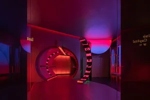 A modern nightclub entrance with metallic and mirrored surfaces.