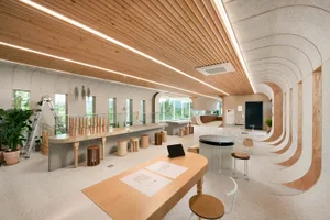 Modern office space featuring wooden furniture and concrete walls
