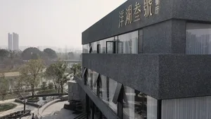 Modern building exterior with gray granite facade and glass windows