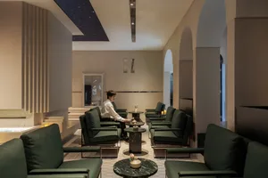 Modern interior design of a hotel lobby featuring leather, marble, and wood finishes