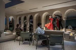 Two couples dancing in a modern interior design bar area with arches, chairs, and tables.