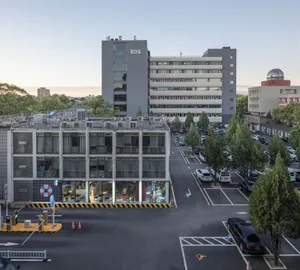 A modern office building with concrete and glass materials.