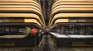 A modern restaurant interior with black marble surfaces and curved lighting fixtures.