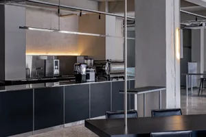 Modern coffee shop with sleek metal and concrete finishes and a minimalist design.