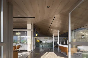 Minimalist design of a coffee shop interior featuring wood elements and industrial-style lighting.