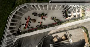 An aerial view of a modern office space with concrete flooring and terrazzo accents.