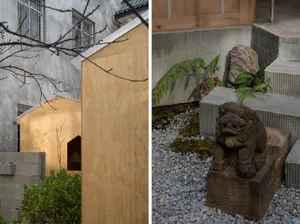 A minimalist interior space featuring a wooden structure, concrete steps, and a stone sculpture with green foliage.